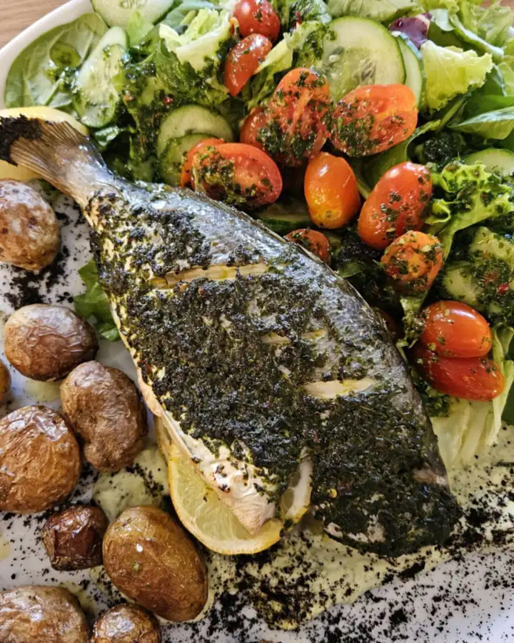 Herb-roasted fish with new potatoes and salad